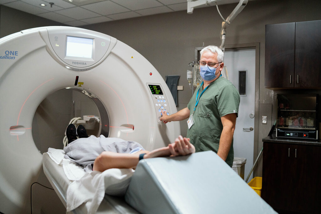 CT Technician aids a patient in a CT Scan
