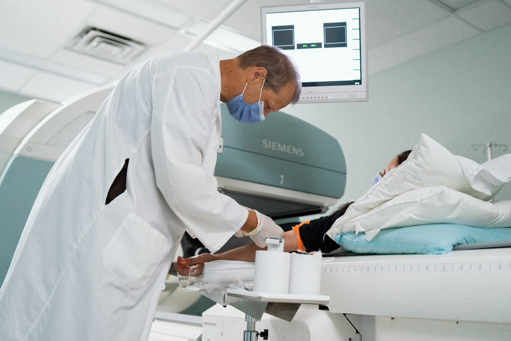 A doctor helps a patient in TADH's Nuclear Medicine